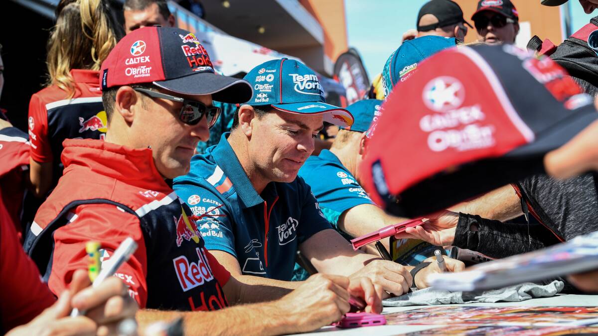 Racing Driver Craig Lowndes signs Autographs for fans behind pit lane Mount Panorama, Bathurst. Photo: AAP Image/Brendan Esposito