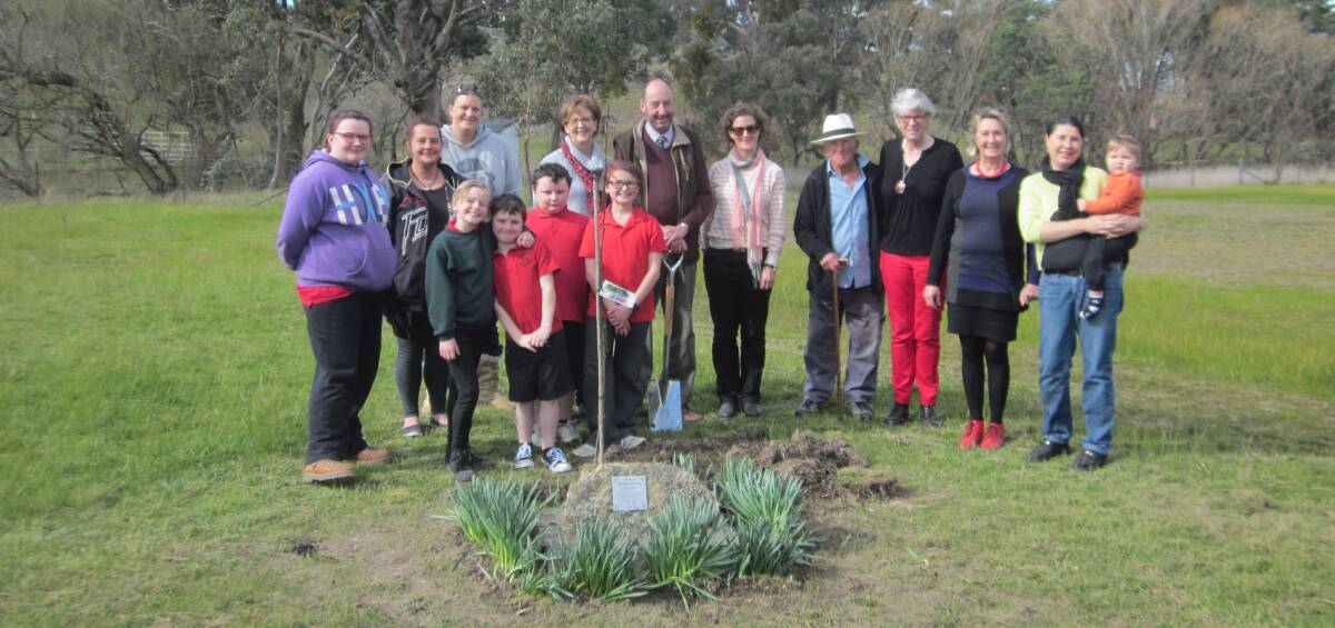 Students and staff from Rugby Public School, along with members of Thellie Horton's family, plant a tree in her memory at the Rugby Recreation Area. 
