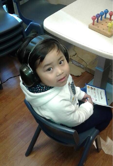4-year-old Hannah having her hearing assessment at a bus stop station. 
