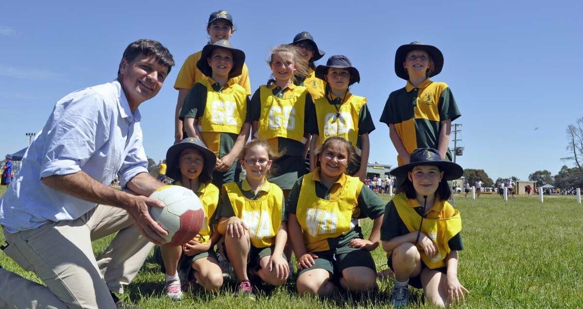 Member for Hume Angus Taylor with students from St Joseph's Primary School at last year's combined schools Netball and Touch Football Carnival. 