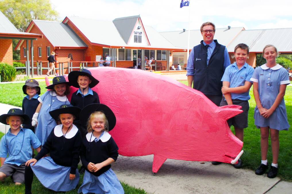 JOB WELL DONE: St Joseph's Primary School students with Country Education Foundation of Boorowa Chairman Justin Fleming and the Pig after completing the painting stage of the construction.  