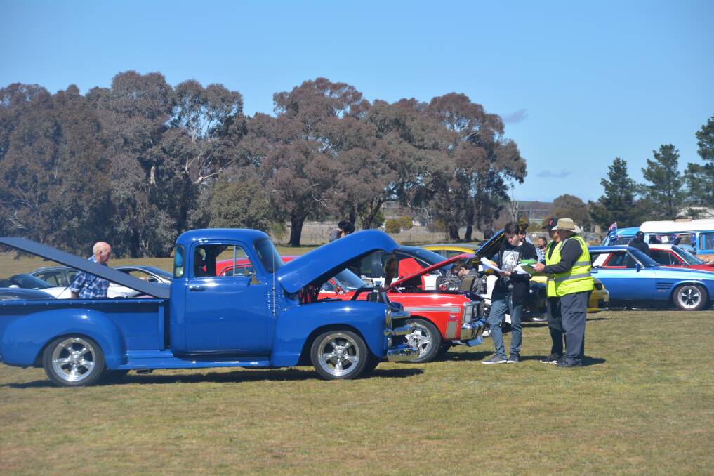 Shined up and shown off: Judges look over one of the entrants in the Boorowa Show and Shine. Photo by John Snelling. 