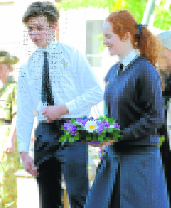Tim Gorham and Molly Hurley prepare to lay a wreath at this year's Anzac Day ceremony. They are both students of Hennessy Catholic College, Young. Photo: RS Williams.