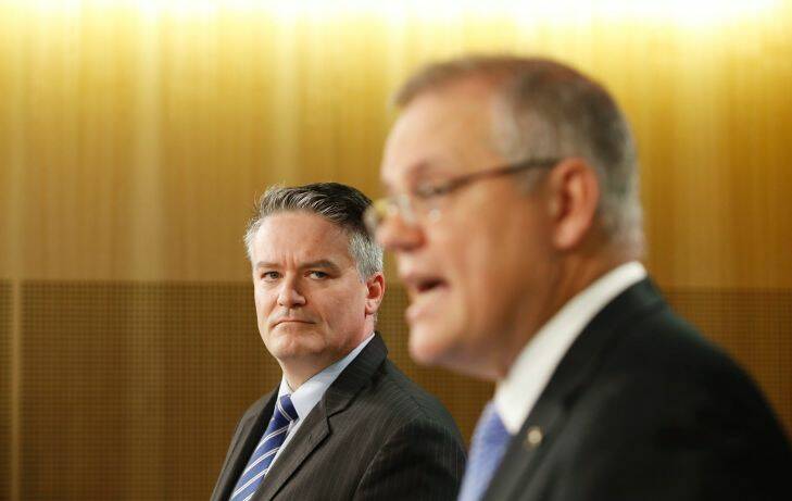 Australian Minister for Finance Mathias Cormann (left) and Treasurer Scott Morrison during a press conference in Sydney, Tuesday, September 26, 2017. The federal government's final budget outcome for 2016/17 was a deficit of $33.2 billion and an improvement on its May forecast. (AAP Image/Daniel Munoz) NO ARCHIVING