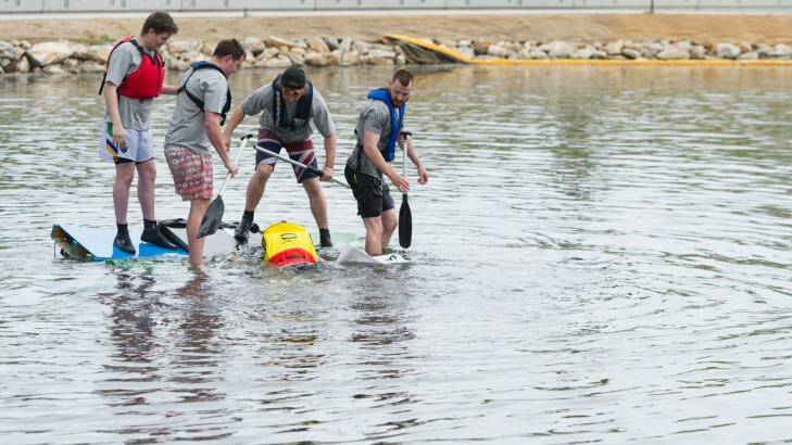 Participants in the boat competition try to save a vessel from sinking at the Queanbeyan River Festival.  Photo: Jay Cronan