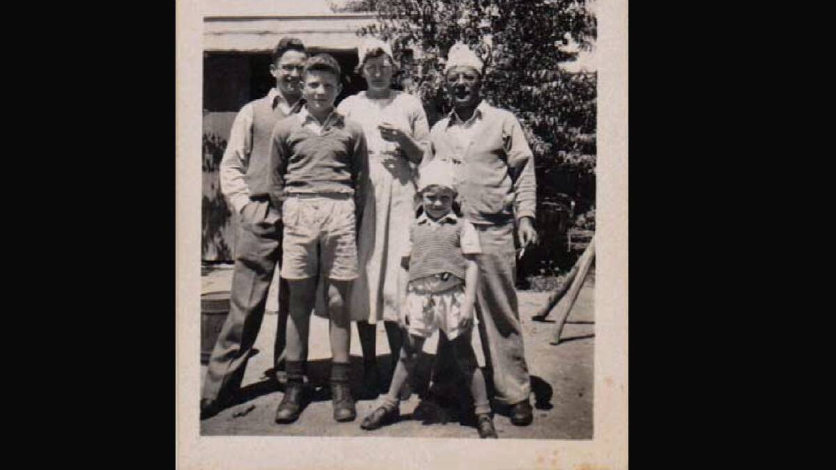 Barry, second from left, in an early 1950s photo behind their shop in Boorowa with (from left) his elder brother Bruce, mother Fay, younger brother David and father Charles.