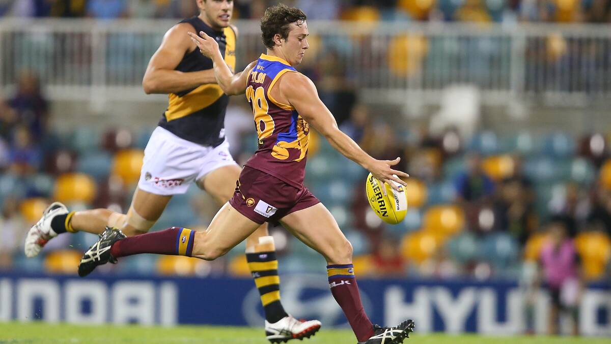 Lewis Taylor of the Lions kicks a goal during the round five AFL match between the Brisbane Lions and the Richmond Tigers at The Gabba on April 17, 2014 in Brisbane, Australia. Photo: Chris Hyde/Getty Images.