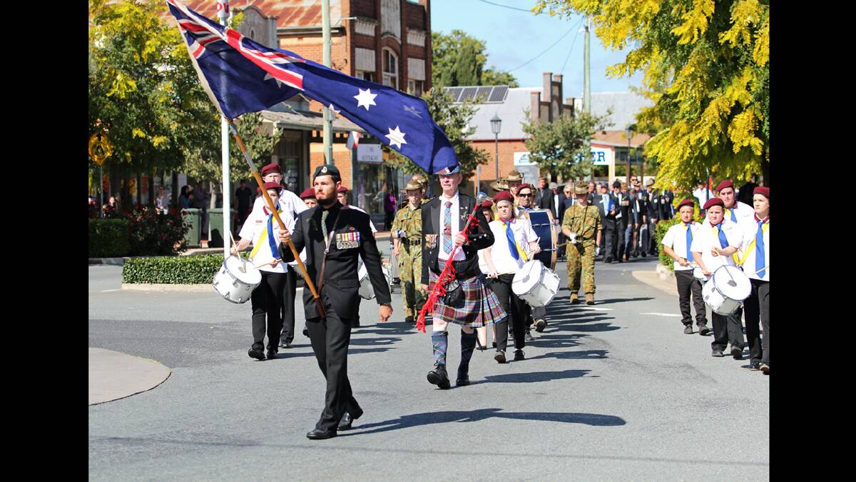 Flag bearer Scott Cox leading last year's Anzac Day March. Following is Ted
Anderson and his drum band, Boorowa Cadets, ex-servicemen and relatives,
schoolchildren and local organisations. People with Boorowa connections, from
as far away as the Northern Territory, have expressed an interest in coming to
Boorowa this year. Photo by RS Williams.