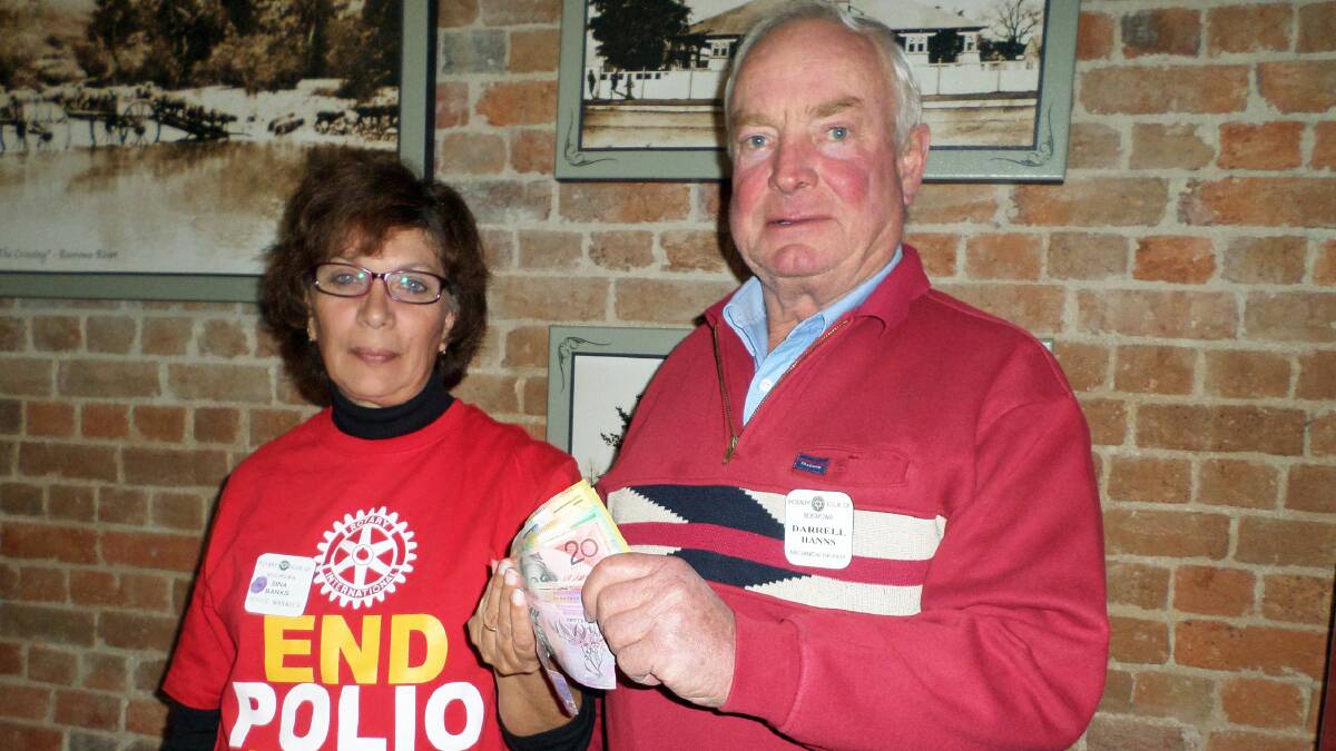 Rotary President Sina Banks handing contributions raised by cutting hair to Darrell Hanns Club Foundation Director going towards the Rotary Club of Boorowa’s annual giving to the “End Polio Now” campaign