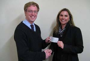 Mr Fleming of Boorowa Rugby Union Club gives a cheque to Kim Blomfield for Boorowa Central School on Monday.