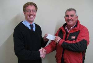 Boorowa Rugby Union Club president Justin Fleming hands a cheque to Dermot McGrath for St Josephs Primary School. The money donated was raised at the club's Ladies Day.
