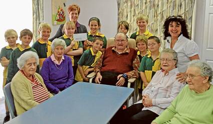 Burrowa House residents, Lesley Mason Nancie Sheridan, Ron Bryce, Edna Savage and Betty King with staff members Judy-Anne Stokehill and Margie Hurley and St Joseph's Mini Vinnies students.