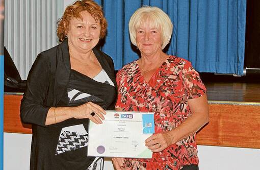 TAFE Illawarra Institute Director Dianne Murray presents graduate Elizabeth Cairns with a Certificate III in Aged Care.