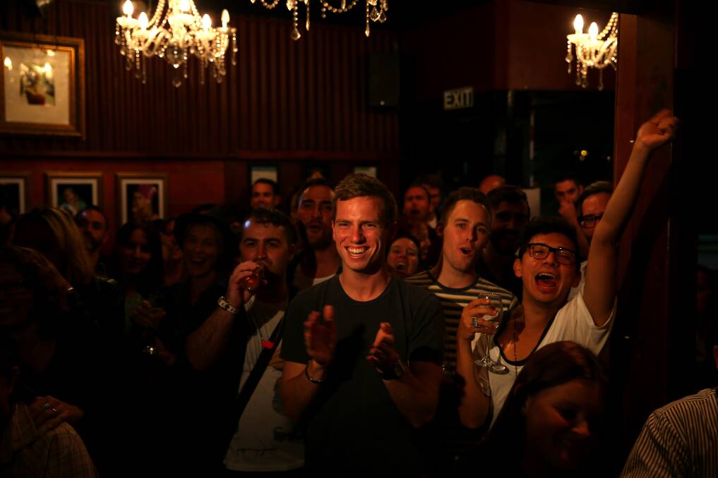 People watch the final reading on Parliament TV at the Caluzzi Bar and Cabaret venue as New Zealand MP's gathered today to vote on the gay marriage bill. Photo: Getty Images