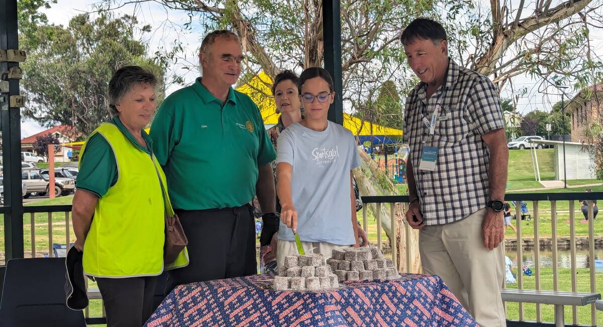 Junior Ambassador, Ivy Taylor, had the honour of cutting the Australia Day cake with Boorowa Citizens of the Year, Sina and Alan Banks and Ambassador, Greg Donovan.