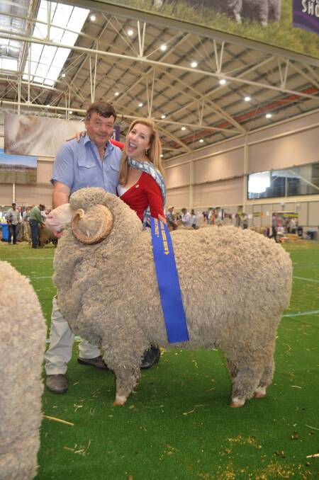 Wal Merriman being congratulated by Merino Ambasadress Catriona Rowntree on exhibiting the champion March-shorn finewool ram.