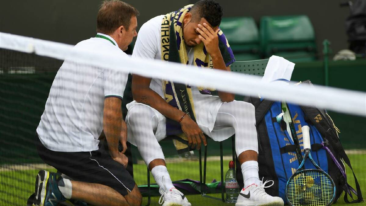 An injured Nick Kyrgios of Australia retires from his first round match at Wmbledon. Photo: Shaun Botterill/Getty Images
