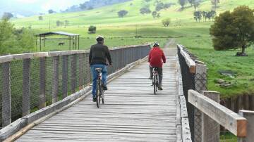 Cyclists ride along a stretch of the High Country Rail Trail east of Tallangatta. Meetings will be held in Boorowa, Harden and Galong in August to discuss a possible Boorowa to Galong Rail Trail. Picture: MARK JESSER