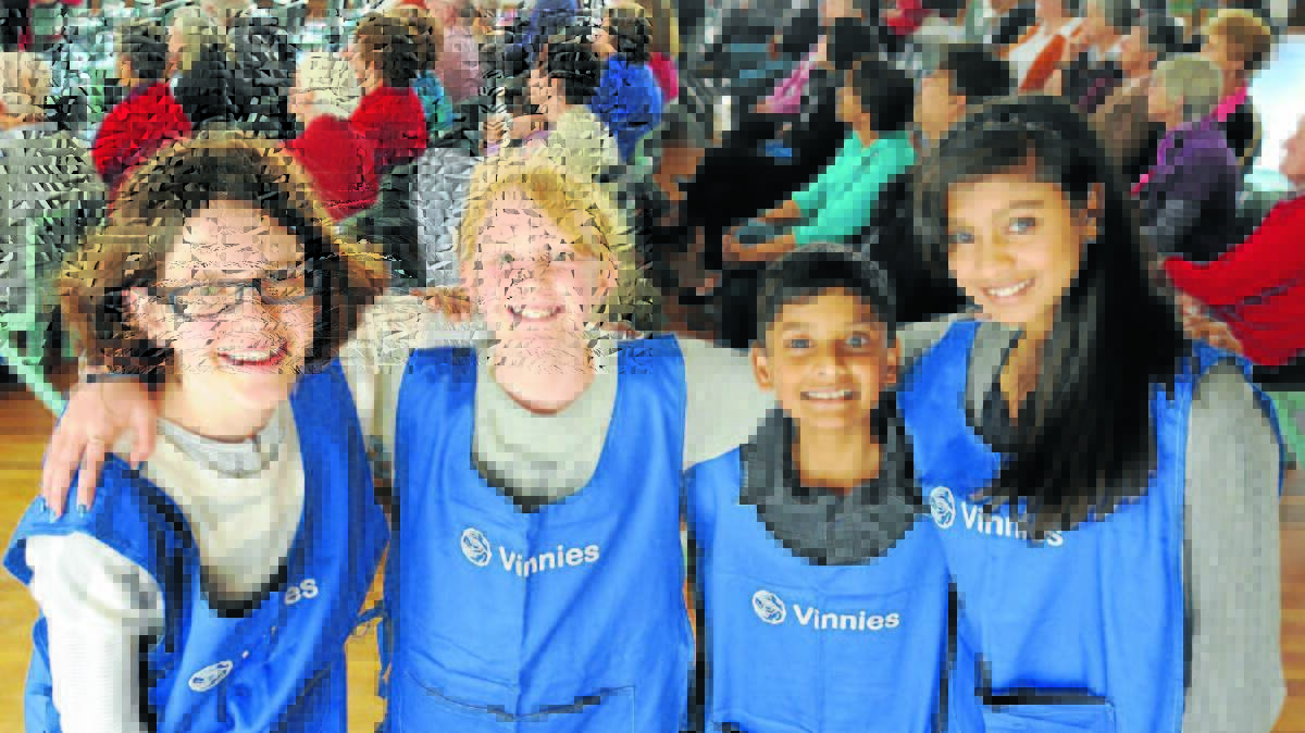 MINI VINNIES: St Vincent de Paul Society young volunteers Inez Russell, Bronte Lawrence, Rohan and Mira Praveen love helping other people. Photo: STEVE GOSCH 0927sgvinnies1
 