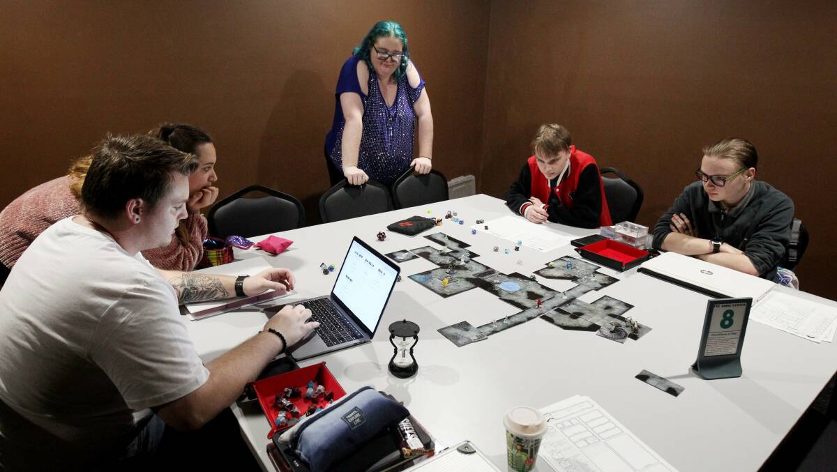 Table top gamers enjoy a round of Dungeons and Dragons at the Game Center in NSW. Picture: Chris Lane