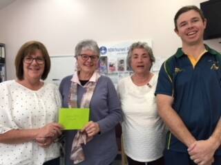 Sharon Hinds and Brendan Shean from the Boorowa Rovers presenting a cheque for $1541 to president Lydia Sheridan and member Maureen Beere. 
