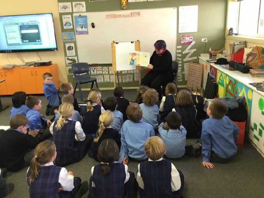 Picture book author and illustrator Christina Booth reads to St Joseph's students. 