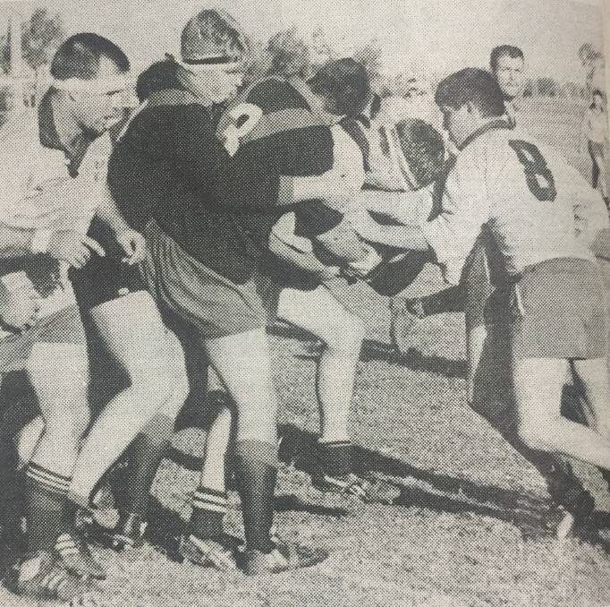 Guy Evans and Sam McGuiness mix it with RMC forwards during a game in 1993. 