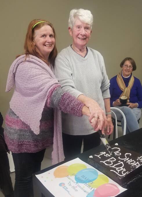 Happy first birthday Boorowa Community Op Shop. Pictured are Lyn Diskon and Chris Hall cutting the birthday cake. 