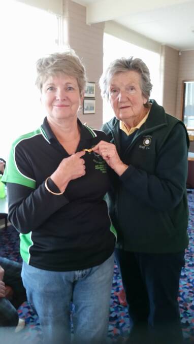Monica Good scored an eagle and was presented an eagle badge from Del Greig.  
