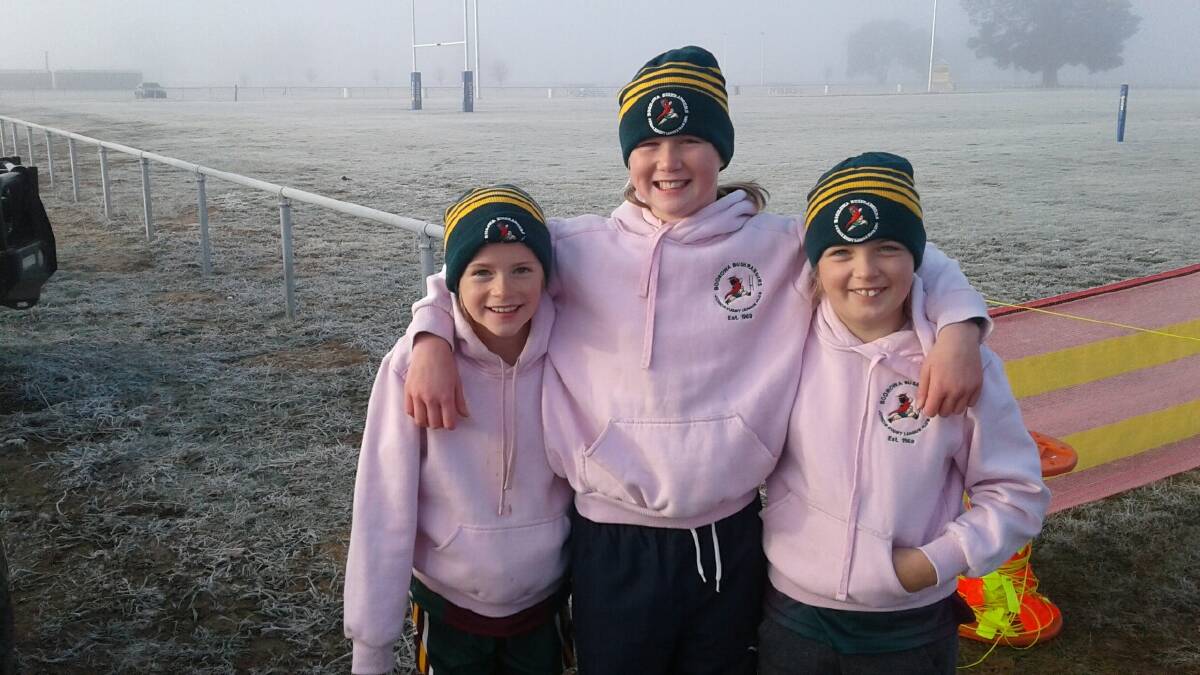 Isabella Piper, Tamsyn Ritchie and Kirsten Piper keeping warm before taking on Cootamundra on Saturday.