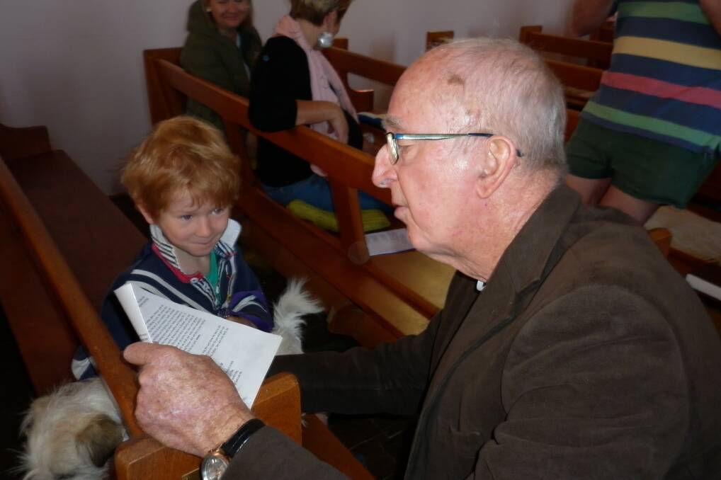Anglican minister the Rev Bob Lindbeck blesses one of the pets at the recent Blessing of the Animals in St Johns Church. This weekend the Diocesan Bishop will be visiting.