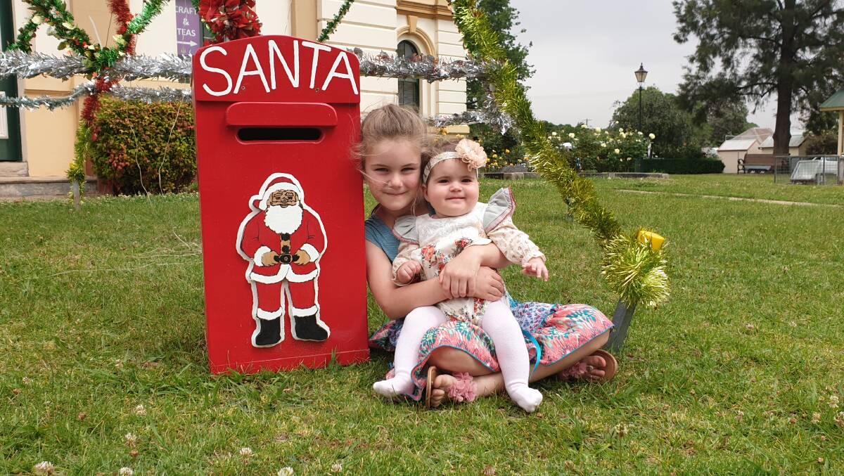 Maya and Quinn Hewitt with the Santa Letterbox, which will be out the front of Boorowa Police Station. Photo: Kelsey Sutor