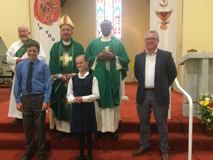 Back Row - Deacon Patrick Whale, Archbishop Christopher Prowse and Father James Onoja. Front Row - Noah Coble, Mylee Taylor and Paul Corcoran. 