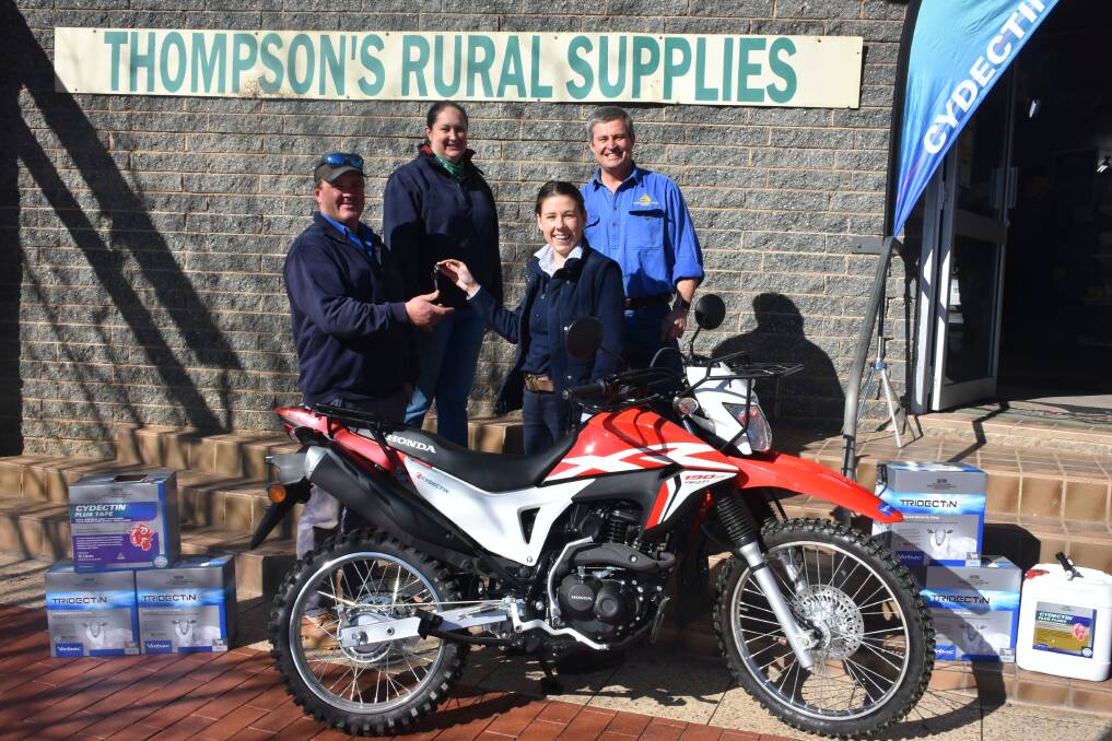 Chris and Sue Braid accept the Honda XR190 from Martin Gay and Emily Fowler.