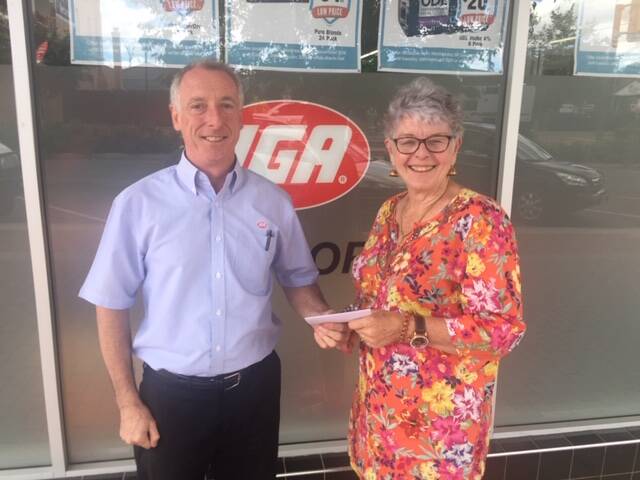David Dwyer presenting President Lydia Sheridan with a cheque for $800.