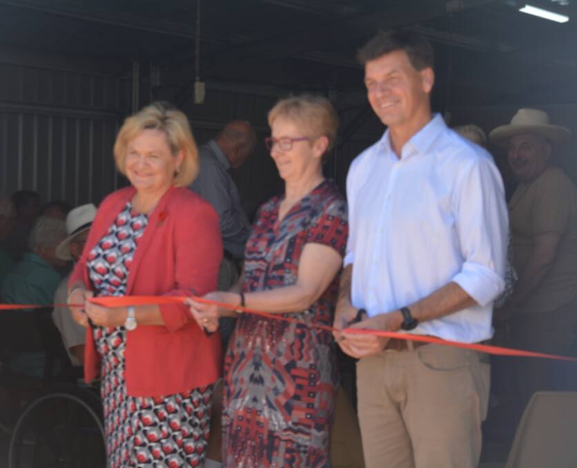 Cr Wendy Tuckerman, Sue Corcoran and Angus Taylor MP cut the ribbon on the Men's Den's new shed.