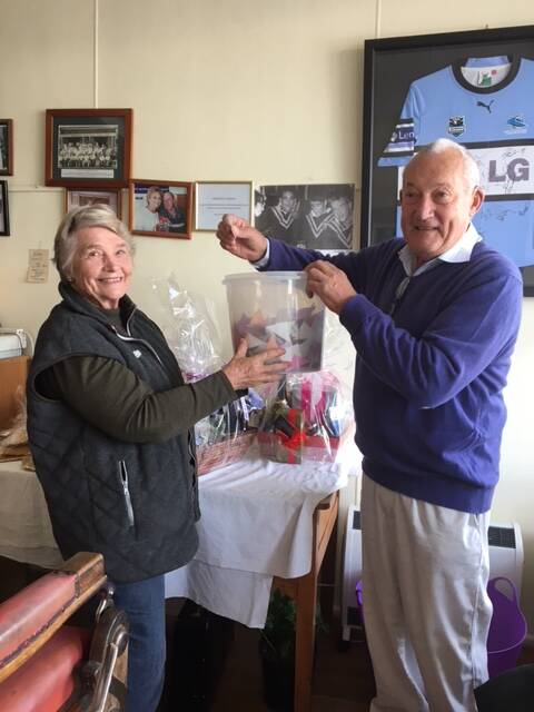  President Judy McGuiness with Christopher Davis drawing the winning raffle ticket.