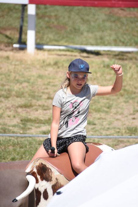 Eight seconds: Mickaya shows her moves riding the mechanical bull. Photo: File.