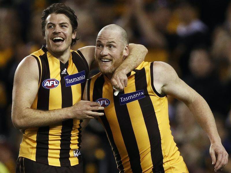 Retiring Jarryd Roughead (R) has kicked six goals in Hawthorn's 70-point AFL thumping of Gold Coast.