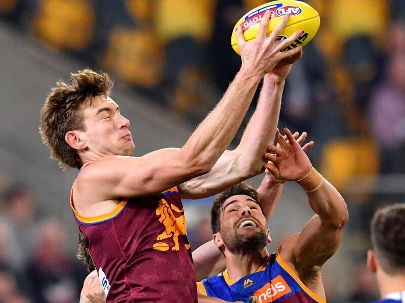 Harris Andrews (left) takes a mark for the Brisbane Lions against North Melbourne.