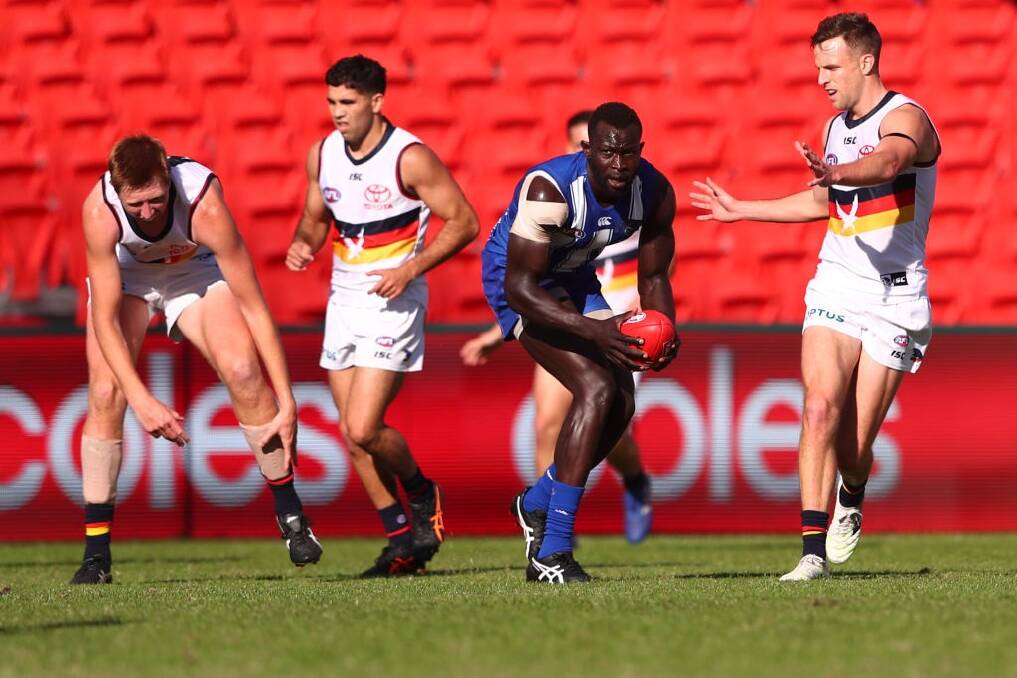 North Melbourne's Majak Daw takes a mark during his return match against the Adelaide Crows. Photo: Getty Images/Chris Hyde