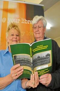 Ms Ottey is pictured with Mr Ryan looking over the Boorowa rugby league book.