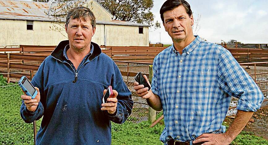 Angus Taylor (right) with Boorowa farmer, Sam McGuiness whose mobile reception at his home and sheds is virtually non-existent.